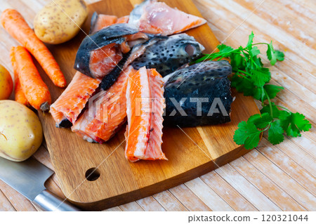 Salmon offal served with vegetables on board 120321044