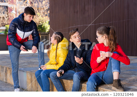 Teenage friends spending time in city streets 120321046