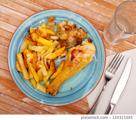 Chicken legs with fried potato and onion 120321085