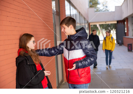 Two teenage students talking near college Two teenage students talking near college 120321216