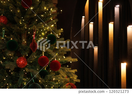 Close-up of a Christmas tree with red balls and bokeh in the background. Close-up of a Christmas tree with red balls and bokeh in the background. 120321273