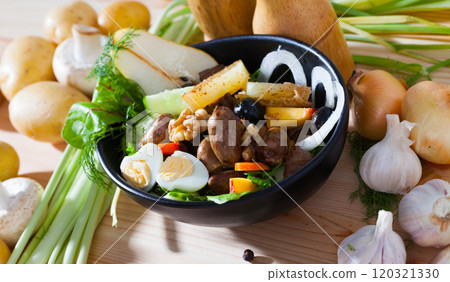 Healthy salad with chicken hearts served in pan 120321330