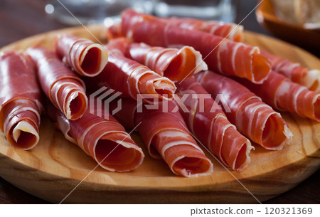 Rolled up slices of dry-cured ham 120321369