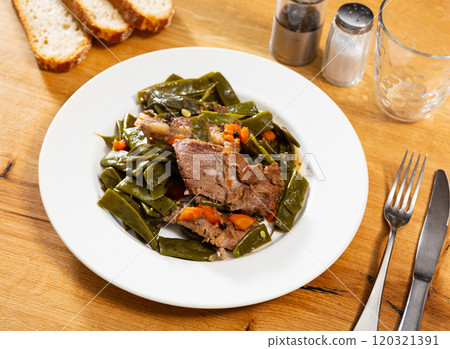 Appetizing beef stew with green beans, carrot and parsley on plate Appetizing beef stew with green beans, carrot and parsley on plate 120321391