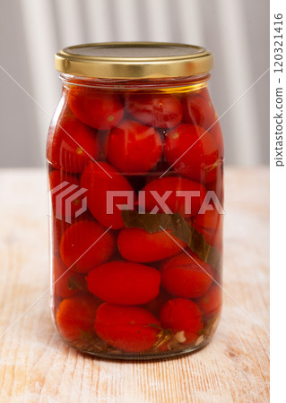 Marinated tomatoes in closed jar 120321416