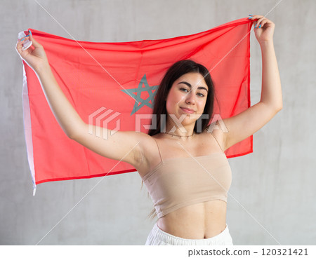 Young woman with flag of Morocco posing in studio 120321421