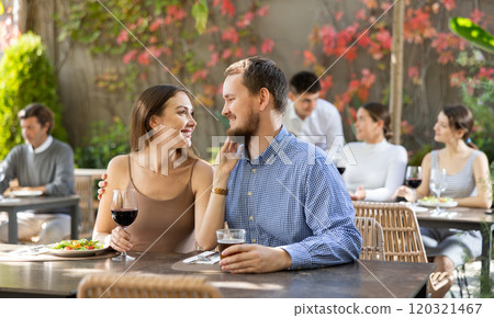 Couple man and woman eating and talking in restaurant Couple man and woman eating and talking in restaurant 120321467