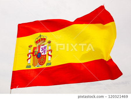 Spain flag on blue sky. Close up waving flag of Spain. Spain flag on blue sky. Close up waving flag of Spain. 120321469