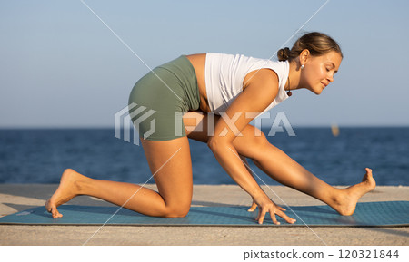 Portrait of sporty girl practicing various yoga poses on seashore Portrait of sporty girl practicing various yoga poses on seashore 120321844