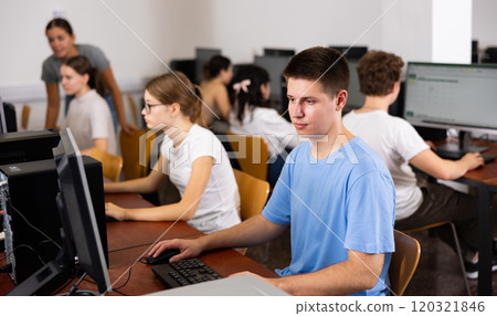 Schoolboy working with computers in classroom 120321846