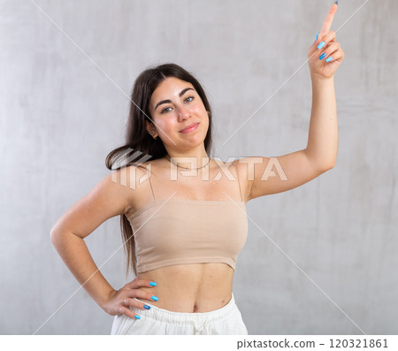 Young smiling woman gesturing in studio Young smiling woman gesturing in studio 120321861