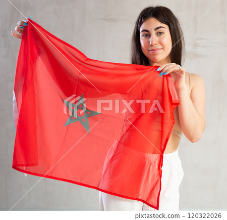 Happy young woman with flag of Monaco against unicoloured background Happy young woman with flag of Monaco against unicoloured background 120322026