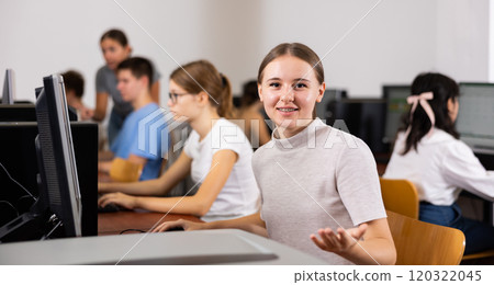 Portrait of positive girl in computer class 120322045