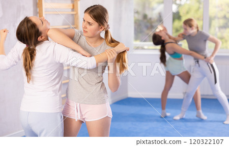 Females practicing self defence moves 120322107