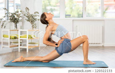 Young girl doing Crescent Low Lunge Pose Anjaneyasana Young girl doing Crescent Low Lunge Pose Anjaneyasana 120322133