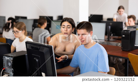 Teenager boy and girl studying in computer class 120322152