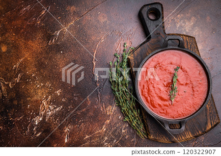 Tomato sauce passata in a skillet , traditional recipe of italian cuisine. brown background. top view Tomato sauce passata in a skillet , traditional recipe of italian cuisine. brown background. top view 120322907