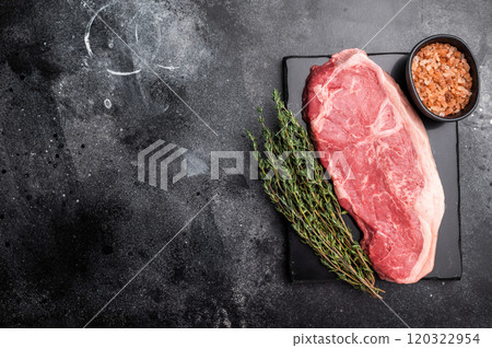 Raw striploin beef steak, New York strip steak. black background. top view Raw striploin beef steak, New York strip steak. black background. top view 120322954