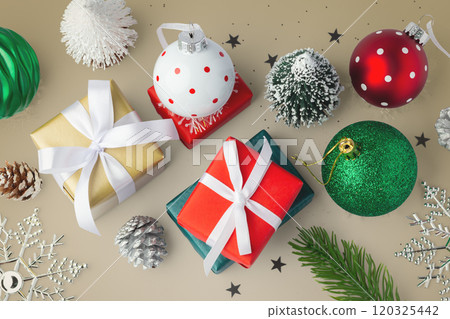 Gift boxes with christmas balls and tree decor on gold background 120325442