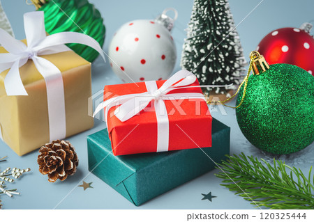 Gift box present with christmas balls and decoration on blue table 120325444