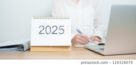 2025 Year Calendar on table with business woman using laptop computer, working and writing in office. countdown, Happy New Year, Resolution, Year End and New Start and Goals Plan Action Concept 2025 Year Calendar on table with business woman using laptop computer, working and writing in office. countdown, Happy New Year, Resolution, Year End and New Start and Goals Plan Action Concept 120326078