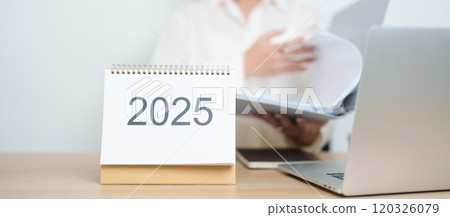 2025 Year Calendar on table with business woman using laptop computer, working and writing in office. countdown, Happy New Year, Resolution, Year End and New Start and Goals Plan Action Concept 2025 Year Calendar on table with business woman using laptop computer, working and writing in office. countdown, Happy New Year, Resolution, Year End and New Start and Goals Plan Action Concept 120326079