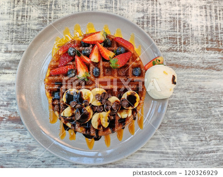 waffles ice cream fruit and sauce on wooden table waffles ice cream fruit and sauce on wooden table 120326929