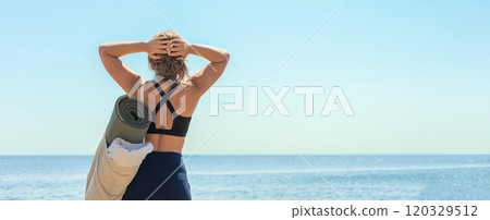 Active fitness yoga woman standing on cliff beach contemplate sea sky sunny landscape back view 120329512