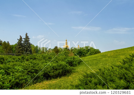 A beautiful hill with bushes. In the distance are the domes of the Kiev-Pechersk Lavra. Kyiv 120329681