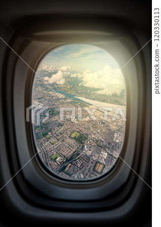 the serene beauty from an airplane window, featuring the wing silhouetted against an expansive, cloud-filled sky, instilling a sense of height and peacefulness. 120330113