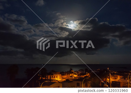 Night landscape. The light of the moon over the sea and the city nightlife Night landscape. The light of the moon over the sea and the city nightlife 120331960