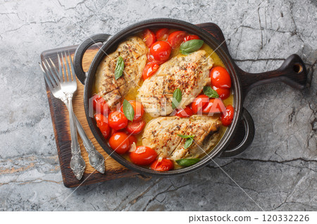 Chicken Pomodoro is an Italian dish made with tender breast smothered in fresh tomato sauce made with cherry tomatoes and fresh herb sclose up on the pan. Horizontal top view Chicken Pomodoro is an Italian dish made with tender breast smothered in fresh tomato sauce made with cherry tomatoes and fresh herb sclose up on the pan. Horizontal top view 120332226