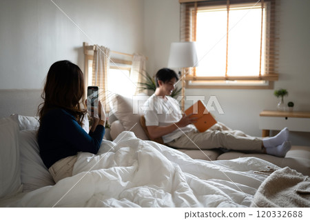 Relaxed couple enjoying a peaceful morning together in cozy home Relaxed couple enjoying a peaceful morning together in cozy home 120332688