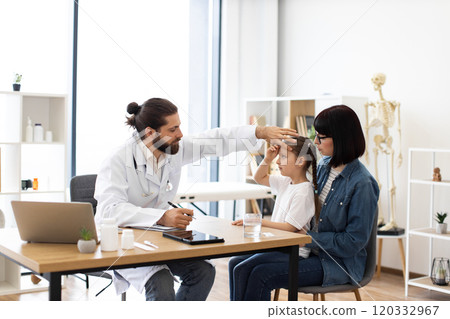 Mother with daughter visiting doctor for a health checkup 120332967