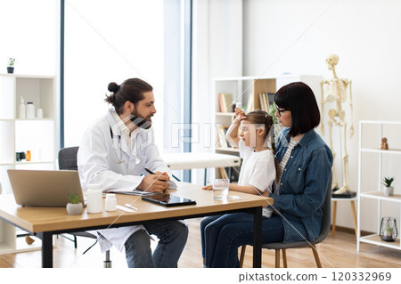 Little girl with mother visiting doctor in clinic office 120332969