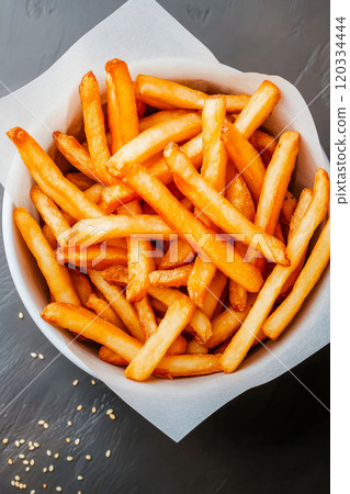 French fries. Pommes frites. Chips. French fries in a paper wrap with ketchup dip 120334444
