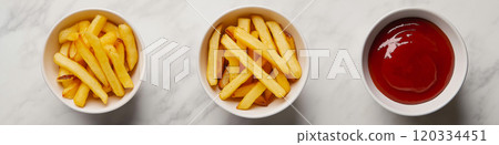 French fries. Pommes frites. Chips. French fries in a paper wrap with ketchup dip 120334451