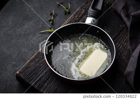 Melted butter on in iron pan Melted butter on in iron pan 120334822