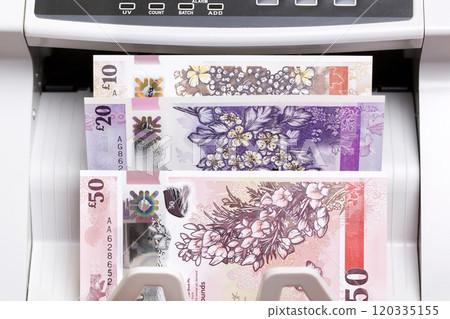 Irish pound in the counting machine 120335155