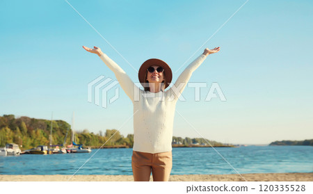 Happy smiling traveler woman on sunny beach, joyful girl enjoying on sea coast background Happy smiling traveler woman on sunny beach, joyful girl enjoying on sea coast background 120335528