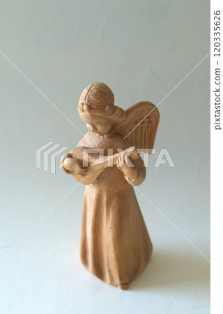 Carved wooden angel statue 120335626