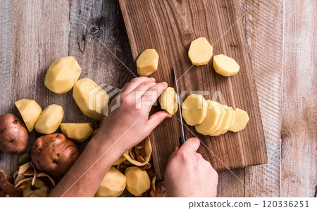 hands cutting potato 120336251