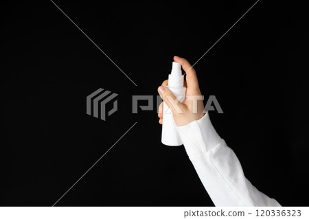 Hand with a spray can on a black background. Special product for spraying Hand with a spray can on a black background. Special product for spraying 120336323