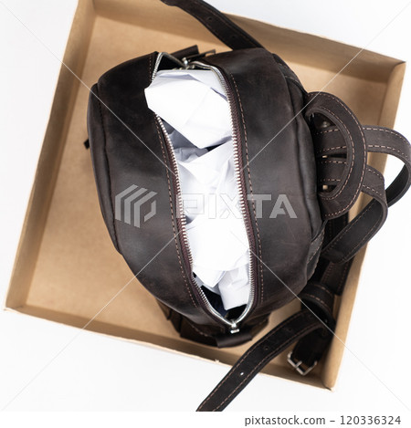 Proper storage of leather accessories. Backpack with paper inside in a box. 120336324