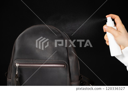 Applying the spray to a leather backpack, accessories care Applying the spray to a leather backpack, accessories care 120336327