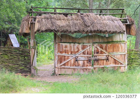 Old wooden gate in countryside. Traditional wooden farmhouse. Village ethnographic gates. Vintage exterior. Daylight. Old wooden gate in countryside. Traditional wooden farmhouse. Village ethnographic gates. Vintage exterior. Daylight. 120336377
