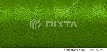 Texture of threads in a spool of green color on a white background Texture of threads in a spool of green color on a white background 120336453