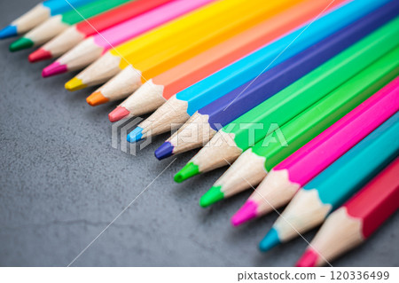 Set of colored pencils lined up on a gray background Set of colored pencils lined up on a gray background 120336499