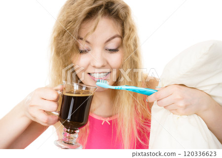 Happy woman holding toothbrush and coffee Happy woman holding toothbrush and coffee 120336623