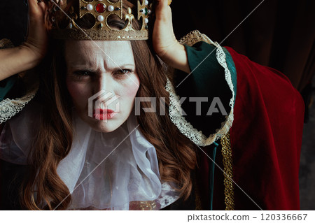 scary medieval queen in red dress with white collar and crown 120336667